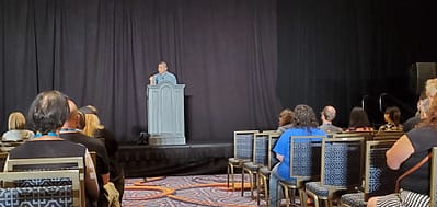 Author Ken Liu stands at a podium.